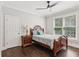 Cozy bedroom with hardwood floors, a ceiling fan, and a large window to let in plenty of sunlight at 1140 River Laurel Dr, Suwanee, GA 30024