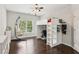 bedroom with a loft bed, desk area, hardwood floors, and large windows for natural light at 1140 River Laurel Dr, Suwanee, GA 30024