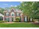 Charming brick residence featuring dormer windows and a well-maintained lawn at 1140 River Laurel Dr, Suwanee, GA 30024