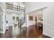 Bright foyer with a staircase, dining area, and hardwood floors creating an elegant entrance at 1140 River Laurel Dr, Suwanee, GA 30024