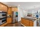 Modern kitchen with stainless steel appliances, granite countertops, wood floors, and ample cabinet space at 1140 River Laurel Dr, Suwanee, GA 30024