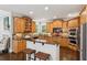 Charming kitchen featuring custom cabinetry, a central island, stainless steel appliances, and stylish backsplash at 1140 River Laurel Dr, Suwanee, GA 30024
