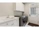 Functional laundry room with modern appliances, a utility sink, and ample storage space at 1140 River Laurel Dr, Suwanee, GA 30024
