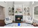 Bright living room features a fireplace with built-in bookshelves, hardwood floors, and natural light at 1140 River Laurel Dr, Suwanee, GA 30024