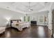Spacious main bedroom boasts a tray ceiling, large windows, and hardwood flooring at 1140 River Laurel Dr, Suwanee, GA 30024