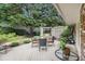 Relax in your serene backyard featuring a wood patio surrounded by lush landscaping and mature trees at 2221 Fairoaks Rd, Decatur, GA 30033