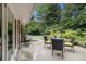 Relax in your serene backyard featuring a wood patio surrounded by lush landscaping and mature trees at 2221 Fairoaks Rd, Decatur, GA 30033