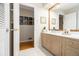 Well-lit bathroom with a double vanity, tile flooring, and an open doorway to another room at 2221 Fairoaks Rd, Decatur, GA 30033