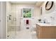 Bright bathroom with a walk-in shower, tiled walls, and a classic vanity at 2221 Fairoaks Rd, Decatur, GA 30033