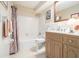 This traditional bathroom features a tub and shower combination, a light vanity, and tile flooring at 2221 Fairoaks Rd, Decatur, GA 30033
