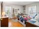 This bedroom is filled with light, has hardwood flooring, and a decorative wallpaper at 2221 Fairoaks Rd, Decatur, GA 30033