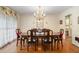 A formal dining room with hardwood floors, a chandelier, and an oval table with chairs at 2221 Fairoaks Rd, Decatur, GA 30033