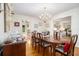 A dining room with wood floors, a chandelier, and a table set for a meal with decorations at 2221 Fairoaks Rd, Decatur, GA 30033