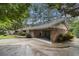 Charming brick home with a covered carport and lush landscaping at 2221 Fairoaks Rd, Decatur, GA 30033