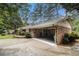 Charming brick home with a covered carport and lush landscaping at 2221 Fairoaks Rd, Decatur, GA 30033