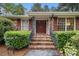 Inviting front entrance with brick steps, mature landscaping, and a charming brick facade at 2221 Fairoaks Rd, Decatur, GA 30033