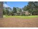 Attractive brick home with a neatly landscaped front yard and mature trees, providing shade and privacy at 2221 Fairoaks Rd, Decatur, GA 30033