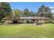 Charming single-story brick home featuring a lush green lawn and meticulously landscaped front yard at 2221 Fairoaks Rd, Decatur, GA 30033