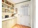 A hallway with built-in shelving, cabinets, a white door, and wood look flooring at 2221 Fairoaks Rd, Decatur, GA 30033