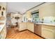 A traditional kitchen with tile floors, cream cabinets, and a stainless steel dishwasher at 2221 Fairoaks Rd, Decatur, GA 30033