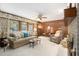 Inviting living room featuring a comfortable sofa, wood paneling, and views of the landscaped backyard at 2221 Fairoaks Rd, Decatur, GA 30033