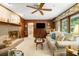 Cozy living room boasts a brick fireplace, wood paneling, built-in shelving, and natural light at 2221 Fairoaks Rd, Decatur, GA 30033