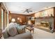 Relaxing living room showcasing a brick fireplace, wood paneling, and cozy seating arrangement at 2221 Fairoaks Rd, Decatur, GA 30033