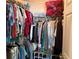 Organized walk-in closet with hanging racks and shelves for clothing and personal items at 4206 Shoreside Cir, Snellville, GA 30039