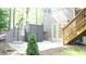 Backyard patio with shed, small tree, stairs to second level, and door into the house at 4241 Hampton Mill Pkwy, Douglasville, GA 30135