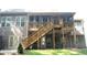 Backyard view of screened porch and deck, with stairs down to the patio and backyard at 4241 Hampton Mill Pkwy, Douglasville, GA 30135