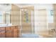 Spacious bathroom with a glass shower, wood cabinetry, and decorative tiling at 4241 Hampton Mill Pkwy, Douglasville, GA 30135