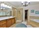 Bathroom with tile flooring, large bathtub, separate shower, and wood vanity at 4241 Hampton Mill Pkwy, Douglasville, GA 30135