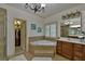 Bathroom features tile floors, large tub, separate shower, and wooden vanity at 4241 Hampton Mill Pkwy, Douglasville, GA 30135