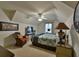 Cozy bedroom featuring an inviting wicker chair, patterned bedding, and a ceiling fan for added comfort at 4241 Hampton Mill Pkwy, Douglasville, GA 30135