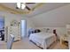 Bright bedroom featuring a ceiling fan, white dresser, and a cozy bed with floral pillows and a white coverlet at 4241 Hampton Mill Pkwy, Douglasville, GA 30135