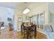 Cozy dining area featuring hardwood floors, a chandelier, and large windows with shutter-style blinds at 4241 Hampton Mill Pkwy, Douglasville, GA 30135