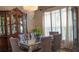 Elegant dining room featuring a mirrored table, comfortable seating for six, and stylish lighting, ideal for hosting gatherings at 4241 Hampton Mill Pkwy, Douglasville, GA 30135