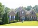 Charming brick two-story home with manicured lawn, mature trees, and beautiful curb appeal in established neighborhood at 4241 Hampton Mill Pkwy, Douglasville, GA 30135
