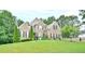 Traditional two-story brick home with manicured lawn and lush landscaping at 4241 Hampton Mill Pkwy, Douglasville, GA 30135