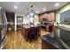 Large kitchen with an island, dark countertops and cabinetry, and hardwood floors at 4241 Hampton Mill Pkwy, Douglasville, GA 30135