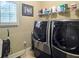 A laundry room with modern washer and dryer and window at 4241 Hampton Mill Pkwy, Douglasville, GA 30135