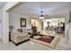 Spacious living room featuring tile flooring, a ceiling fan, a stylish rug, and lots of natural light at 4241 Hampton Mill Pkwy, Douglasville, GA 30135