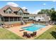 Beautiful backyard with a large in-ground pool, patio seating and lush green lawn at 5585 Lavender Farms Rd, Powder Springs, GA 30127