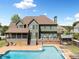 Back exterior of home featuring a large pool, deck, screened porch and fenced yard at 5585 Lavender Farms Rd, Powder Springs, GA 30127