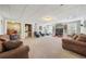 Open basement area with neutral colored carpet, tv area, bar area, and multiple seating options at 5585 Lavender Farms Rd, Powder Springs, GA 30127