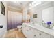 Bathroom featuring a single sink, vanity, toilet, shower with curtain, and tile flooring at 5585 Lavender Farms Rd, Powder Springs, GA 30127