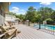 Exterior deck featuring backyard with pool and lounge chairs at 5585 Lavender Farms Rd, Powder Springs, GA 30127