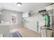 Laundry room with washer, dryer, tile floors, utility sink, and shelving at 5585 Lavender Farms Rd, Powder Springs, GA 30127