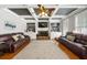 Spacious living room with custom built-ins, a fireplace and coffered ceilings at 5585 Lavender Farms Rd, Powder Springs, GA 30127