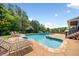 Inviting backyard pool with a diving board and lounge chairs for sunbathing and relaxation at 5585 Lavender Farms Rd, Powder Springs, GA 30127